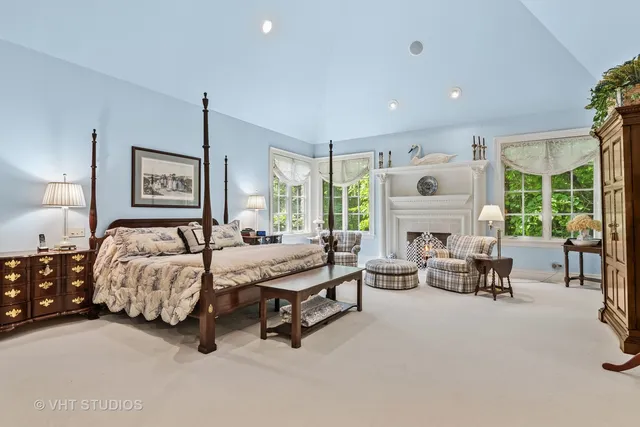 a bathroom with double vanity sinks a large mirror and a shower