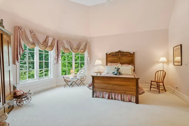 a bedroom with a bed furniture and a large window