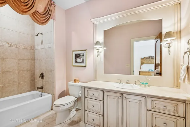 a bathroom with a double vanity sink toilet and shower