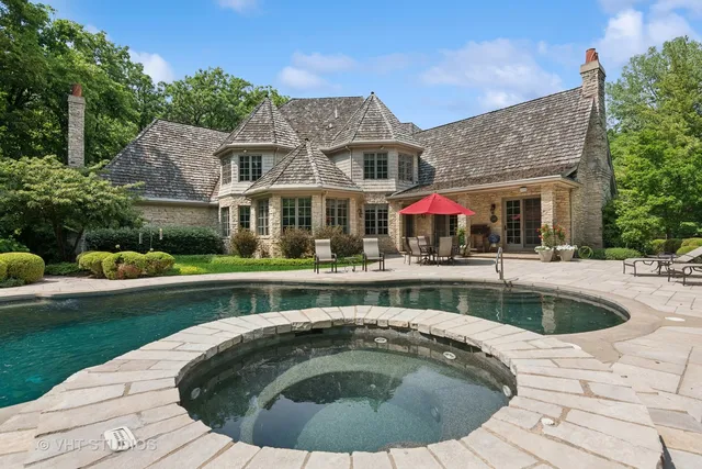 a view of a house with swimming pool and a yard