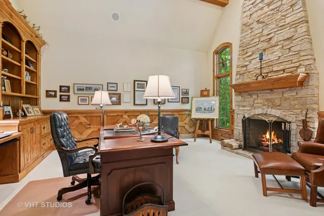 a dining room with furniture a chandelier and wooden floor