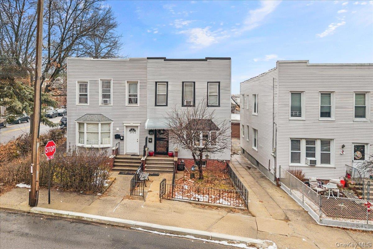 View of front of house with a fenced front yard and a gate