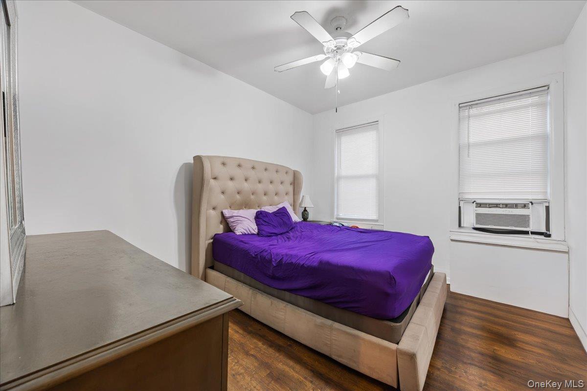 2953 Harding Avenue Bronx, NY 10465 - Photo 18 of 29 Bedroom with a ceiling fan, dark wood finished floors, and cooling unit