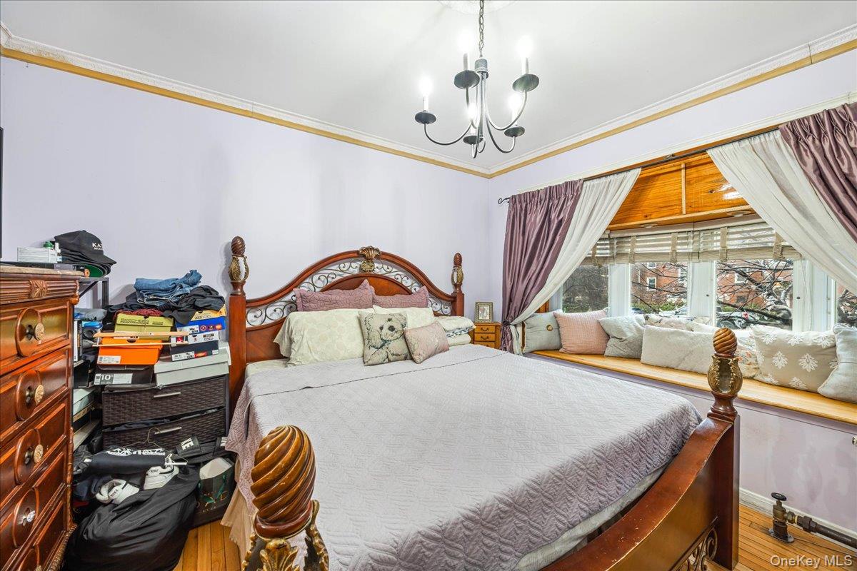 2953 Harding Avenue Bronx, NY 10465 - Photo 10 of 29 Bedroom with a chandelier, crown molding, and wood finished floors