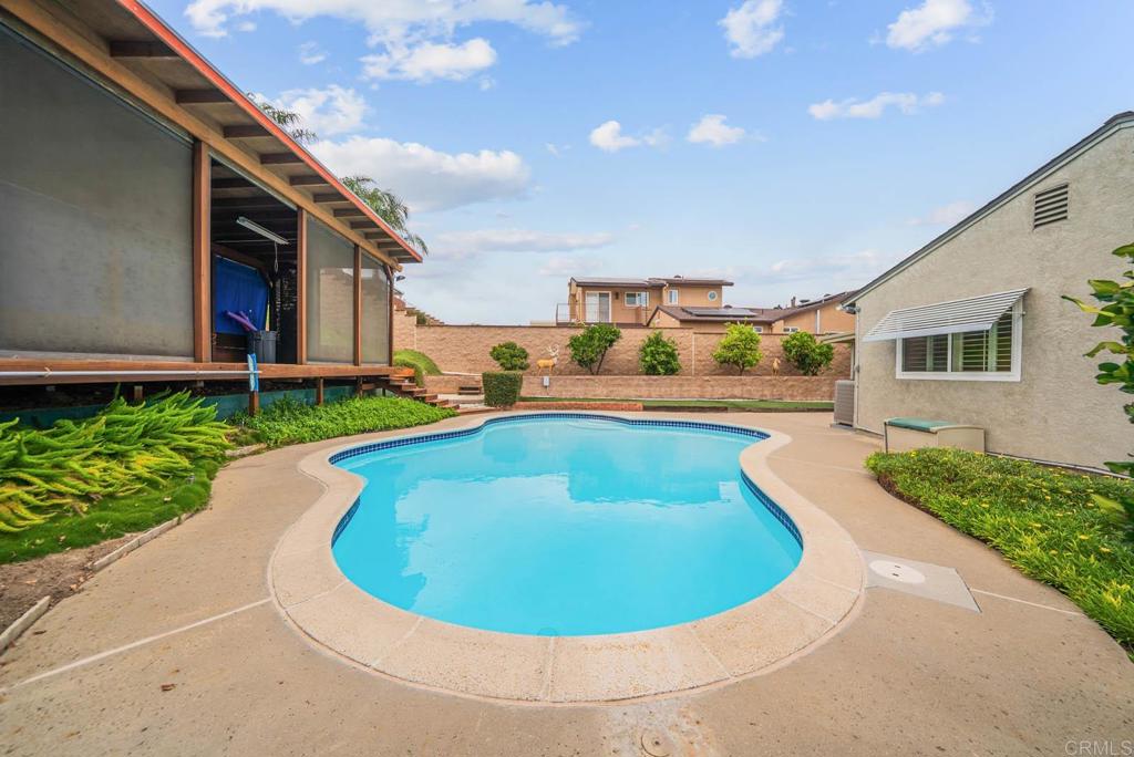 10138 Waynecrest Lane Santee, CA 92071 - Photo 16 of 40 a view of a swimming pool with a yard