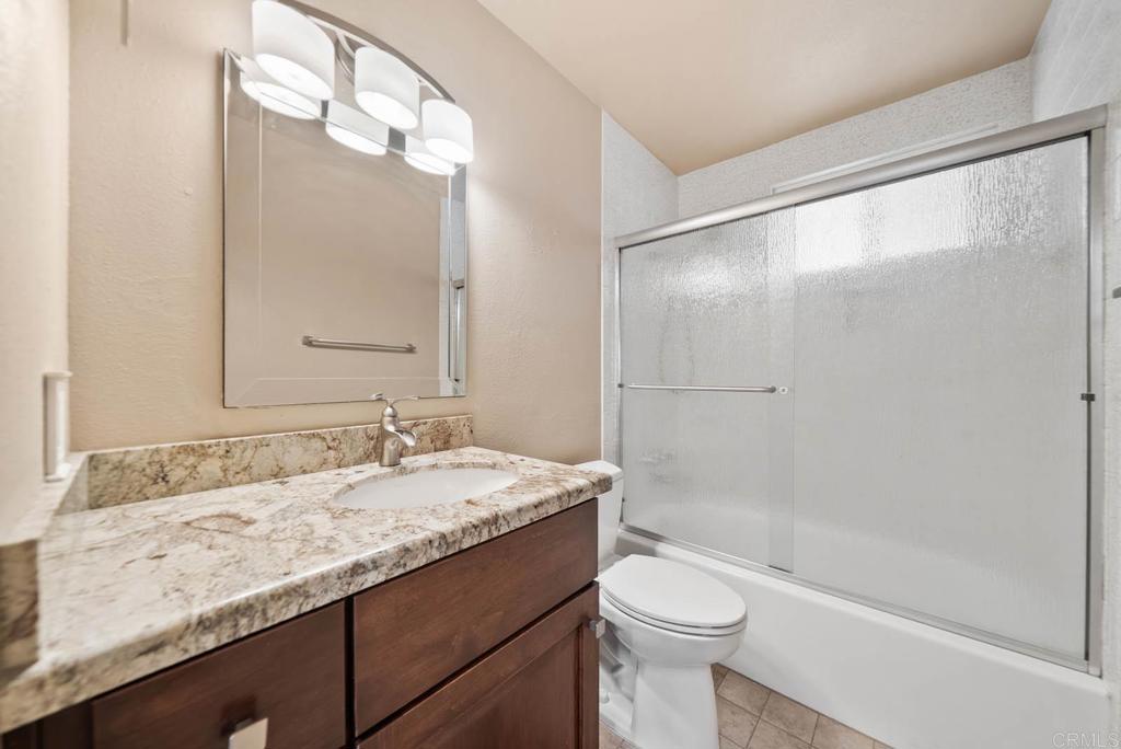 10138 Waynecrest Lane Santee, CA 92071 - Photo 31 of 40 a bathroom with a granite countertop sink toilet and shower