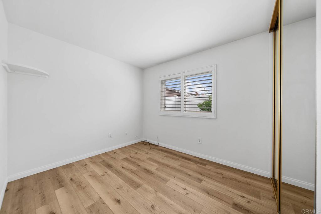10138 Waynecrest Lane Santee, CA 92071 - Photo 32 of 40 an empty room with wooden floor and windows