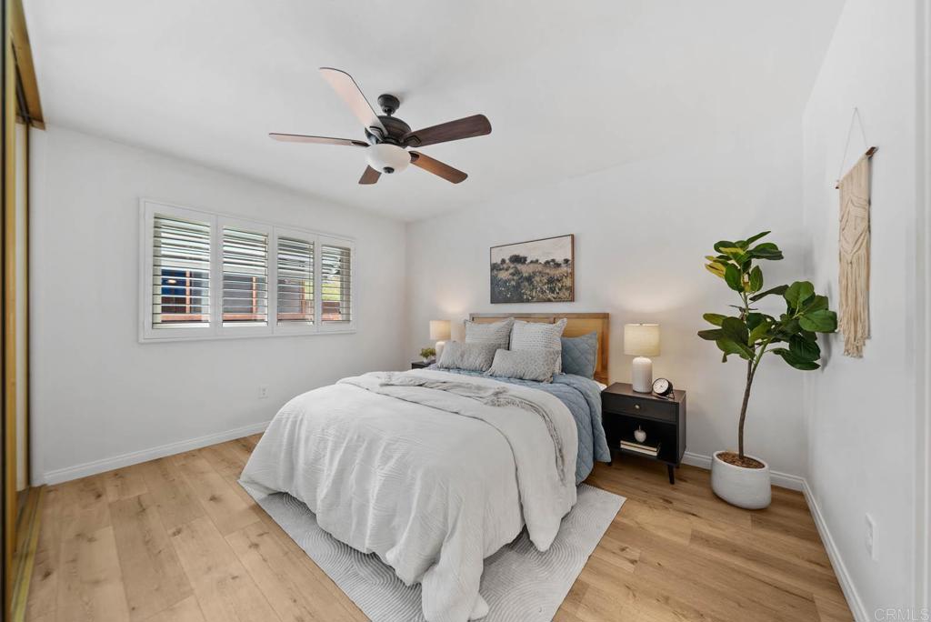 10138 Waynecrest Lane Santee, CA 92071 - Photo 36 of 40 a bedroom with a bed chandelier and a window