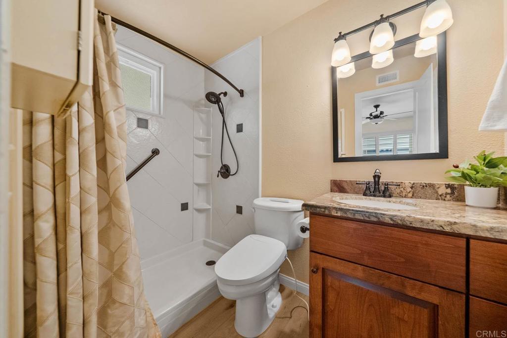10138 Waynecrest Lane Santee, CA 92071 - Photo 39 of 40 a bathroom with a granite countertop sink toilet and shower
