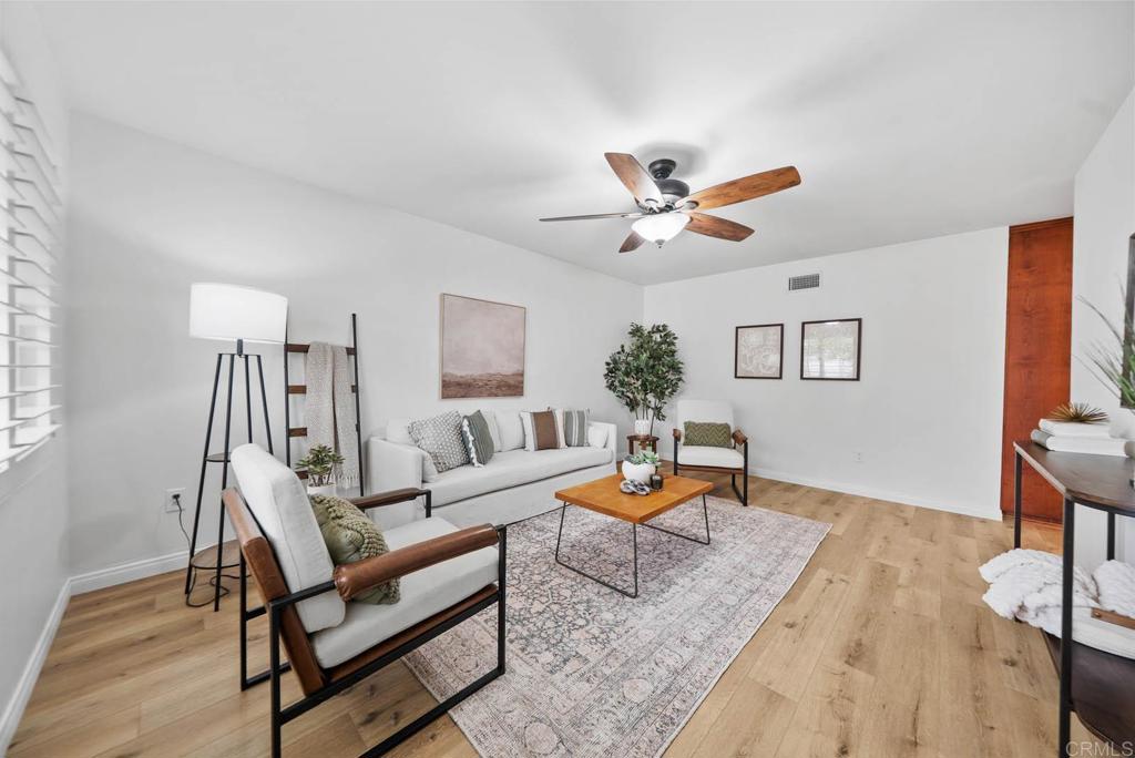 10138 Waynecrest Lane Santee, CA 92071 - Photo 4 of 40 a living room with furniture a rug and a chandelier