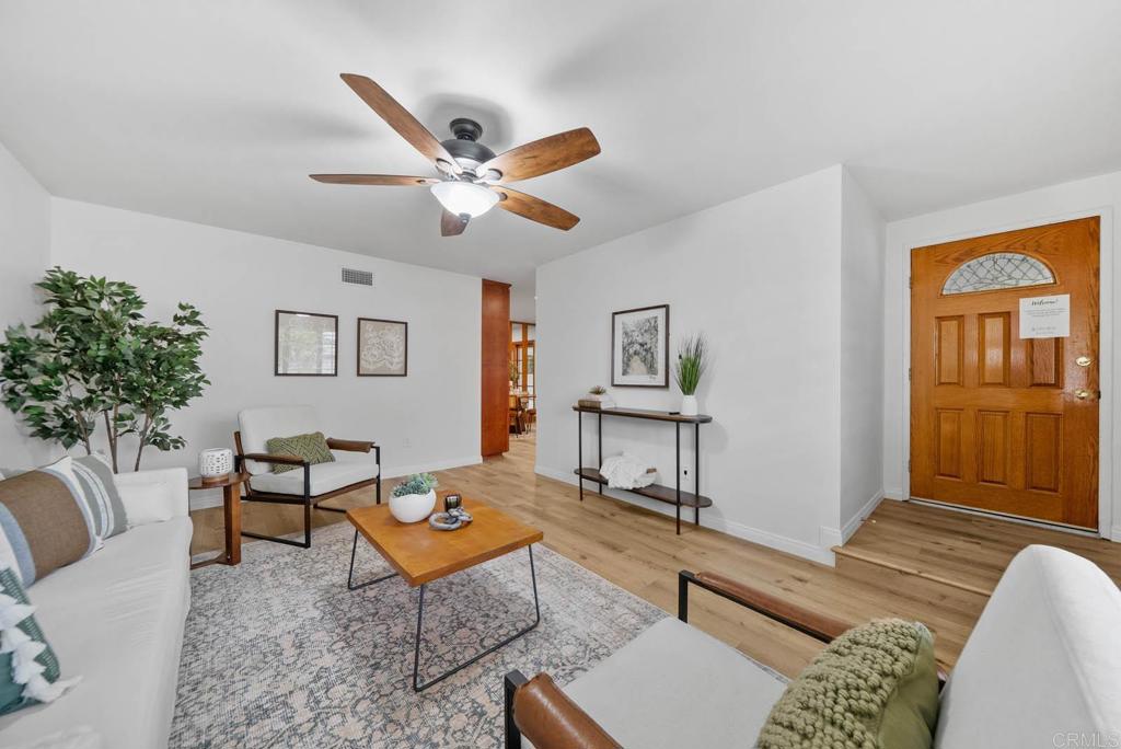 10138 Waynecrest Lane Santee, CA 92071 - Photo 5 of 40 a living room with furniture a window and a potted plant