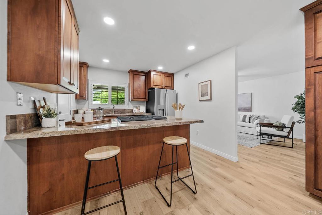 10138 Waynecrest Lane Santee, CA 92071 - Photo 7 of 40 a kitchen with stainless steel appliances granite countertop table chairs sink and cabinets