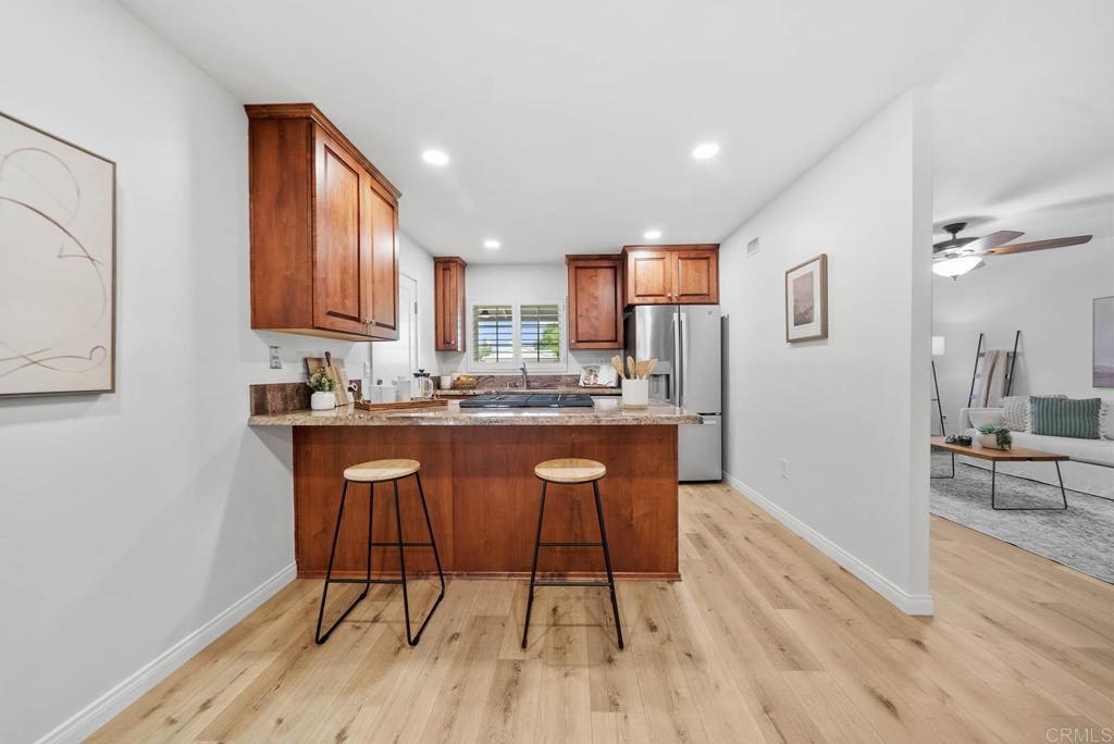 10138 Waynecrest Lane Santee, CA 92071 - Photo 9 of 40 a kitchen with stainless steel appliances granite countertop a stove a sink dishwasher and a refrigerator with wooden floor