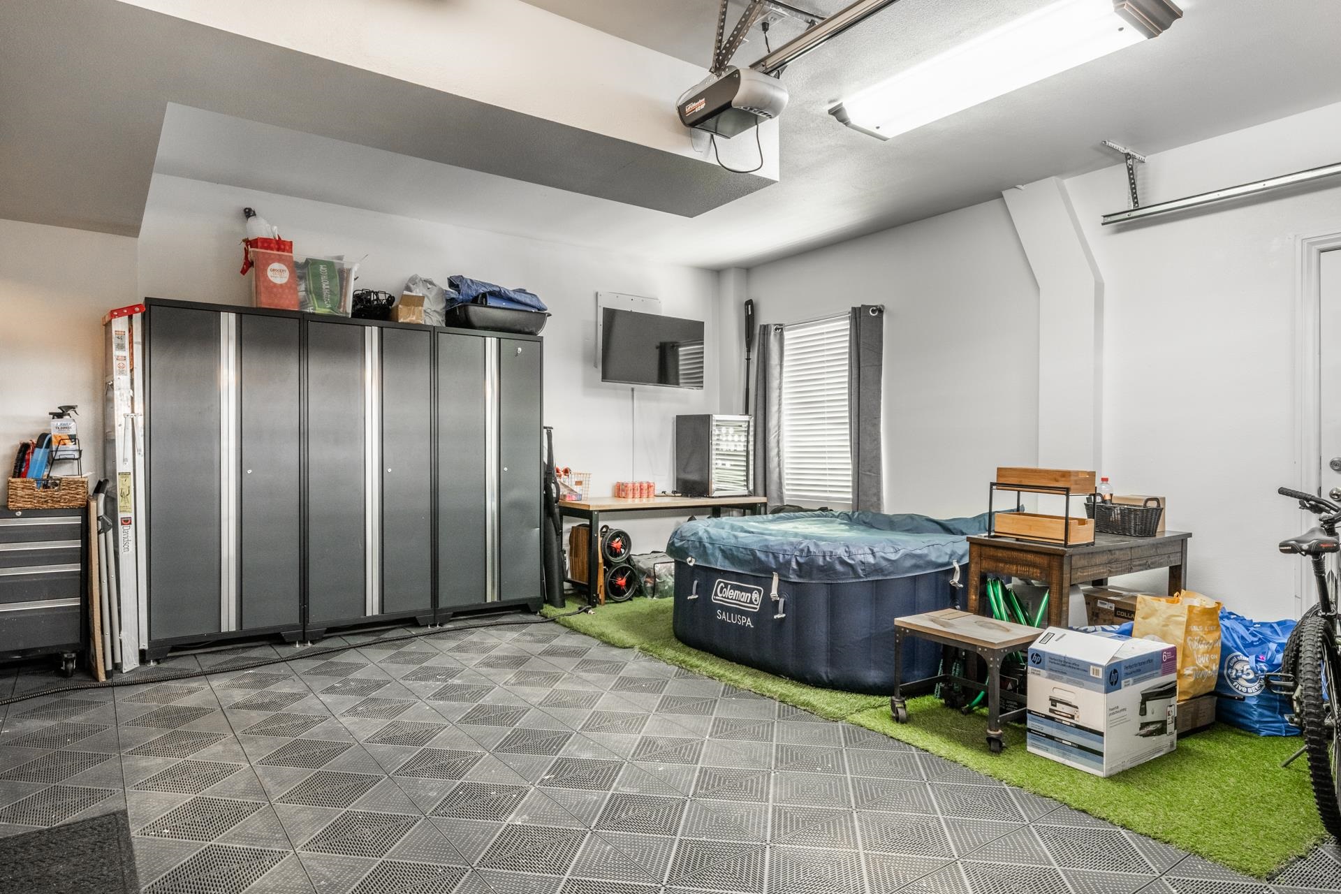1787 Old Mammoth Road, Unit 2 Mammoth Lakes, CA 93546 - Photo 21 of 29 Finished garage space featuring patterned floor tiles, white walls, and a window with blinds
