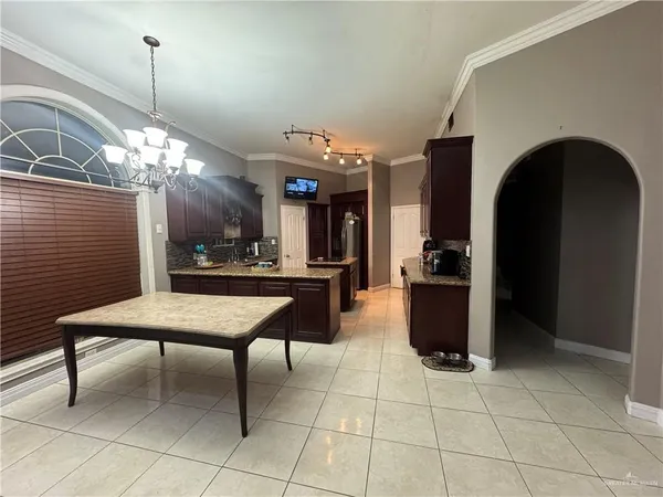 a living room with couches a dining table and kitchen view