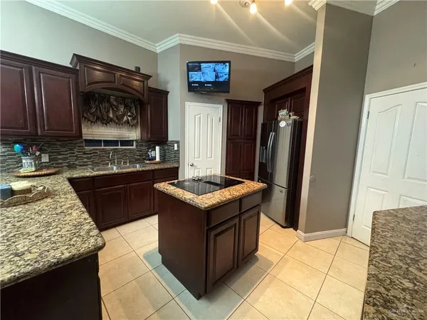 a kitchen with granite countertop a stove and a refrigerator