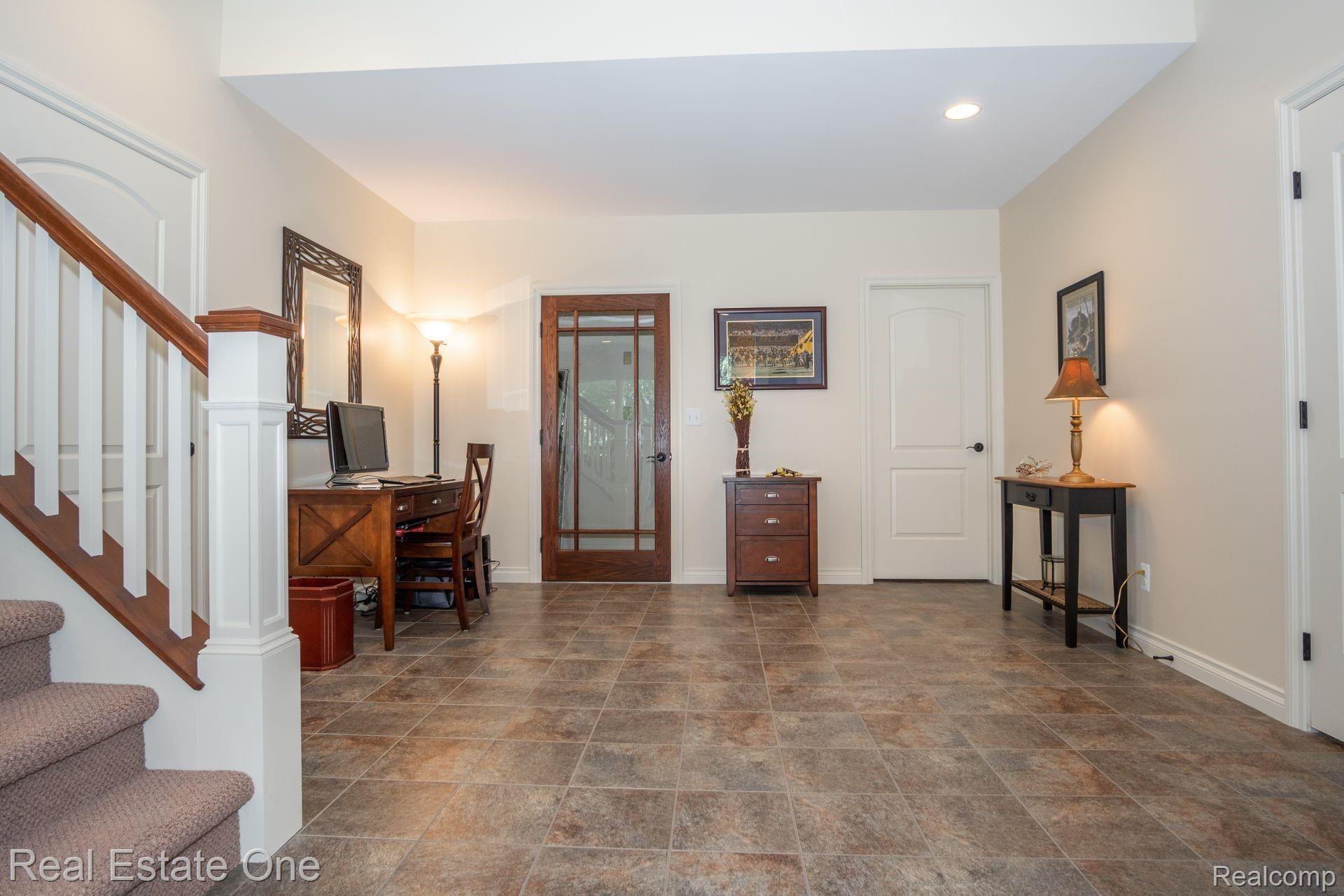 9091 Northpointe Ridge Brighton, MI 48114 - Photo 37 of 56 Step onto your heated floors leading to your wine room.