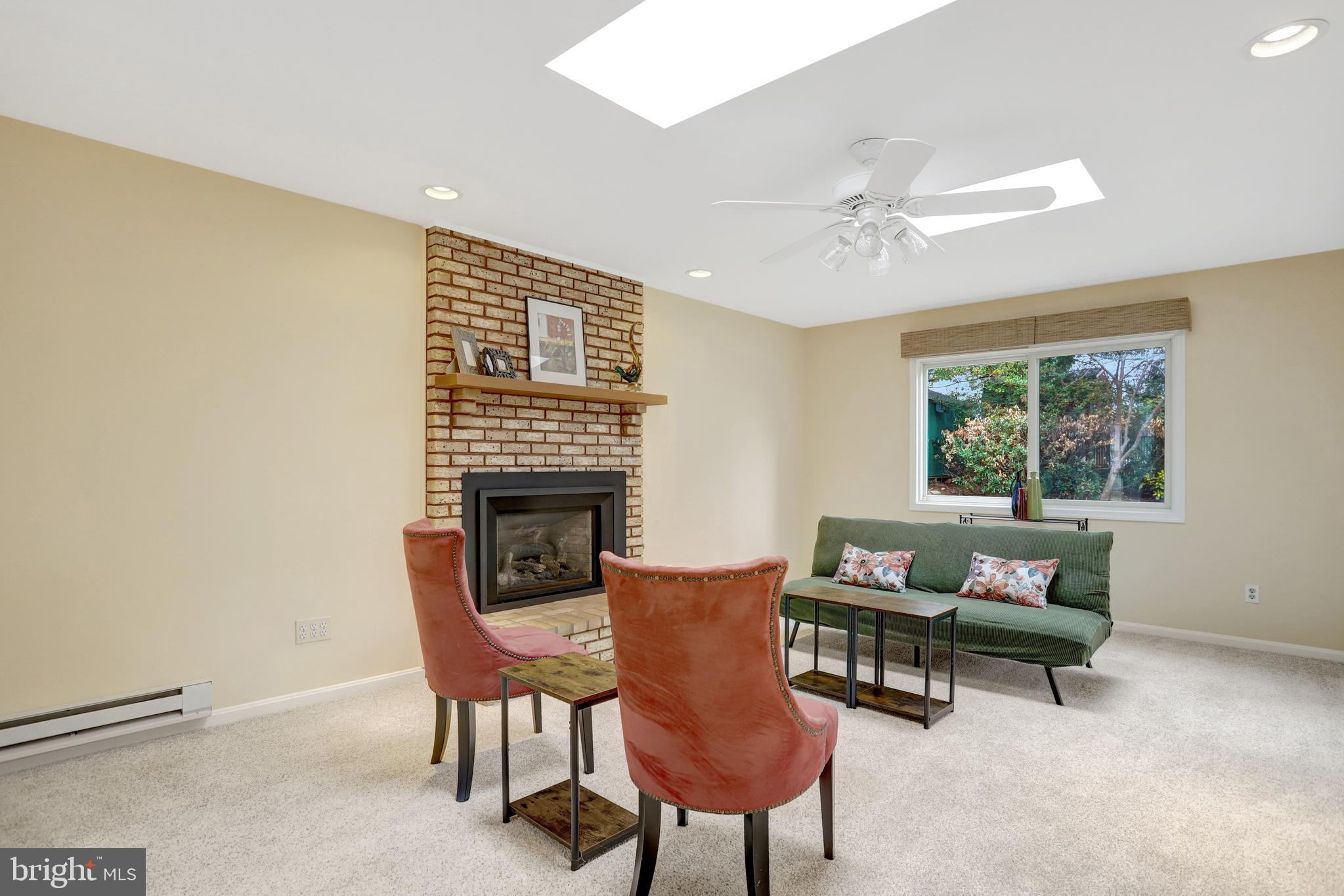 8816 Victoria Road Springfield, VA 22151 - Photo 16 of 76 a living room with furniture and a fireplace