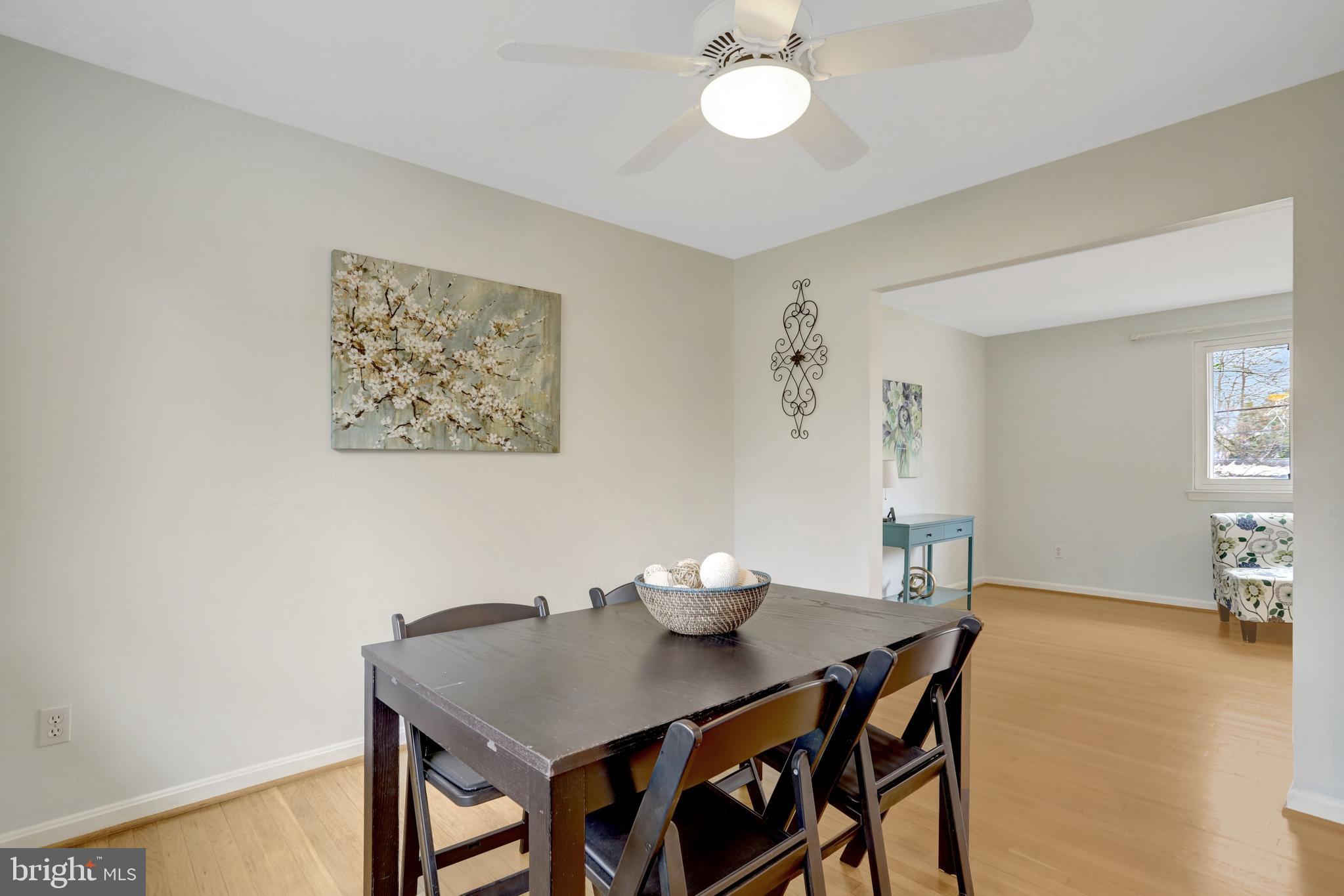 8816 Victoria Road Springfield, VA 22151 - Photo 33 of 76 a view of a dining room with furniture and wooden floor