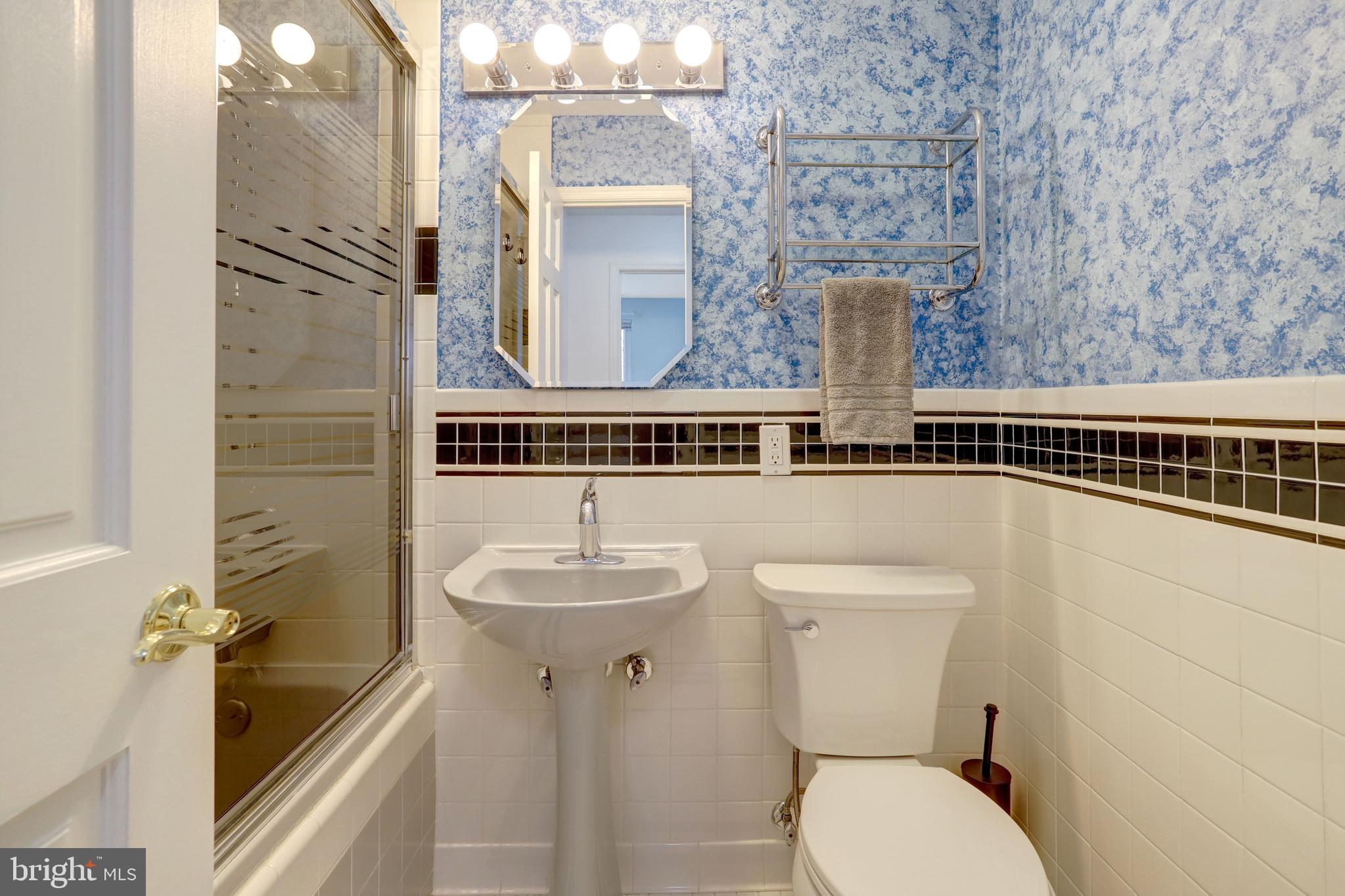 8816 Victoria Road Springfield, VA 22151 - Photo 39 of 76 a bathroom with a toilet sink and mirror