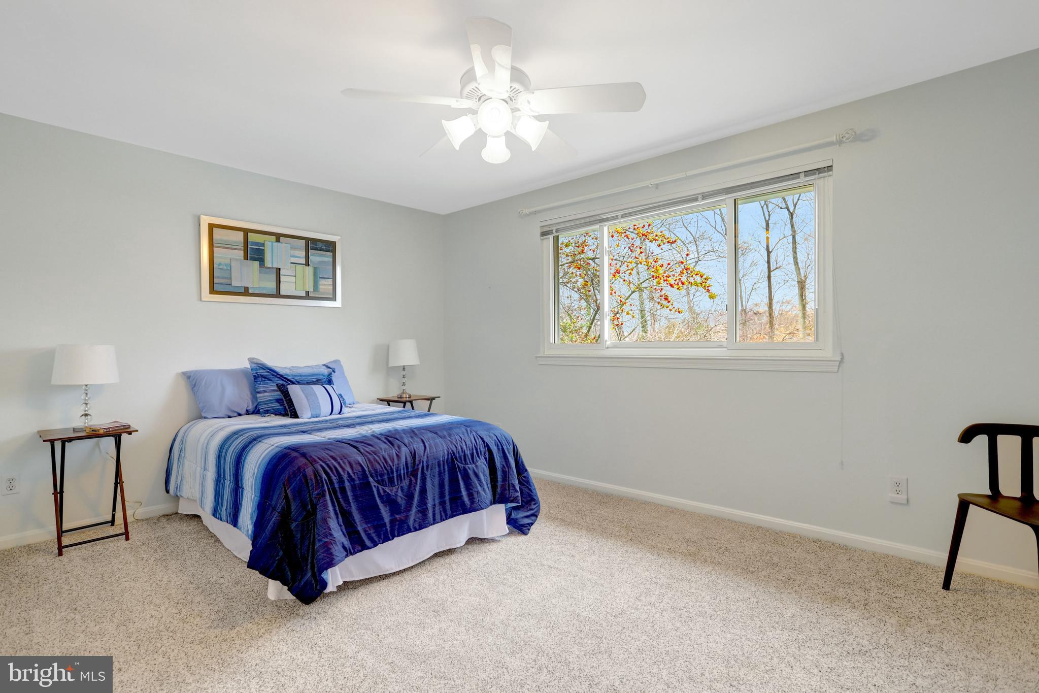 8816 Victoria Road Springfield, VA 22151 - Photo 40 of 76 a spacious bedroom with a bed and a window