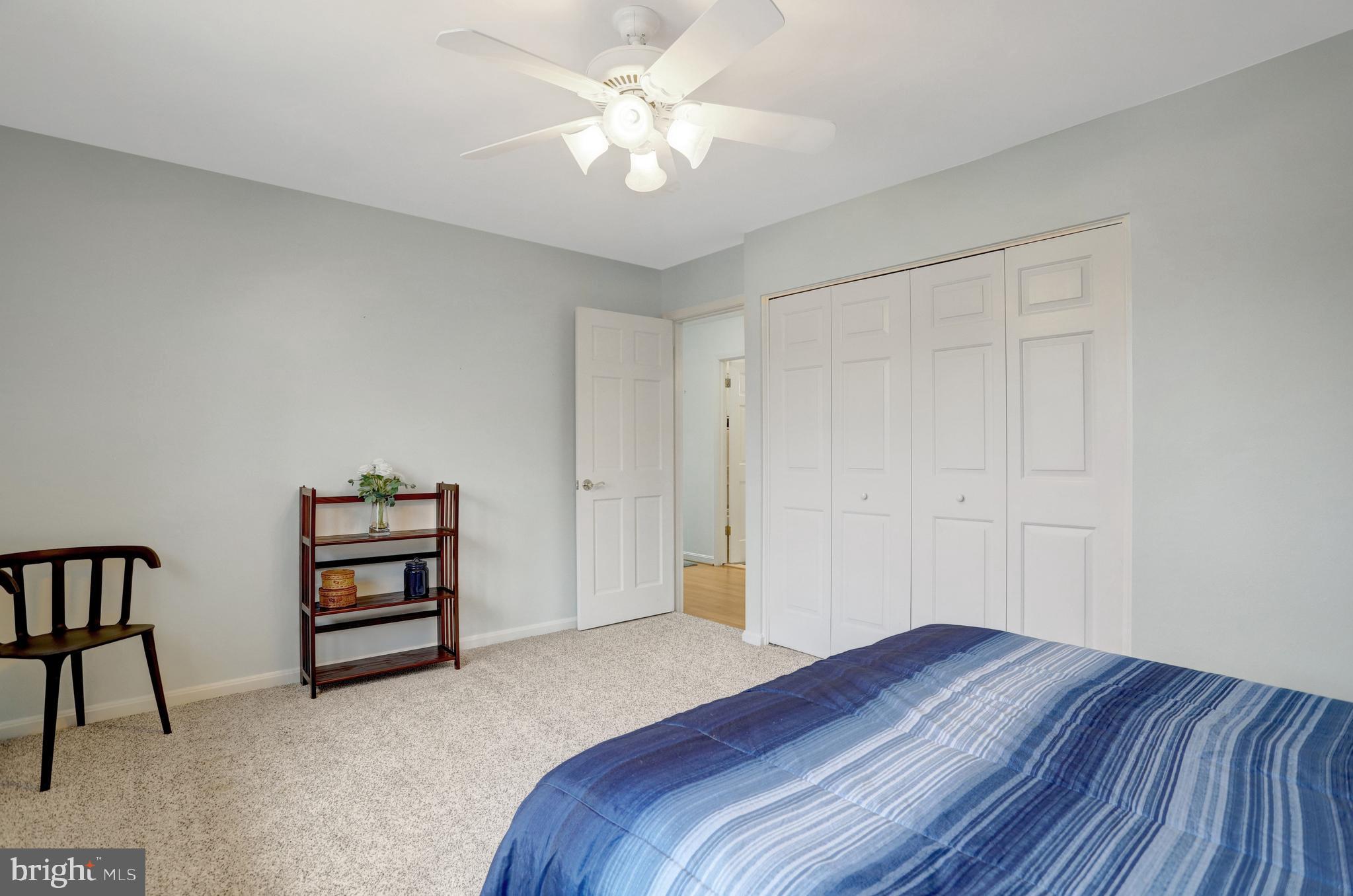8816 Victoria Road Springfield, VA 22151 - Photo 42 of 76 a bedroom with a bed and a chandelier