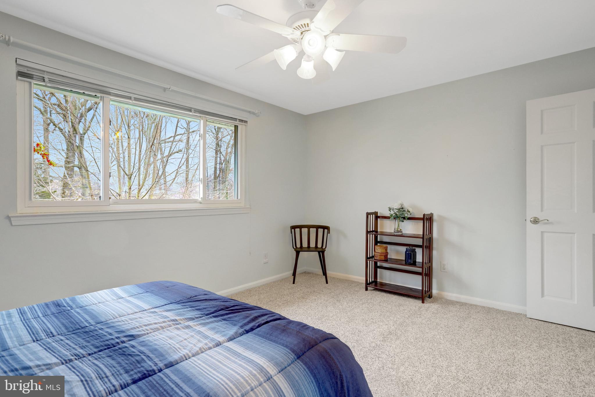 8816 Victoria Road Springfield, VA 22151 - Photo 43 of 76 a bedroom with a bed closet and a window