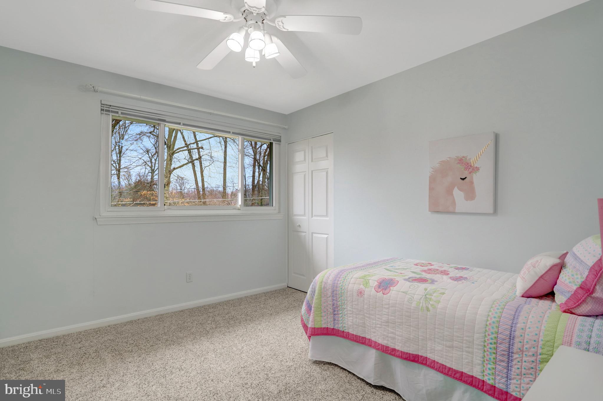8816 Victoria Road Springfield, VA 22151 - Photo 44 of 76 a bedroom with a bed and a chandelier