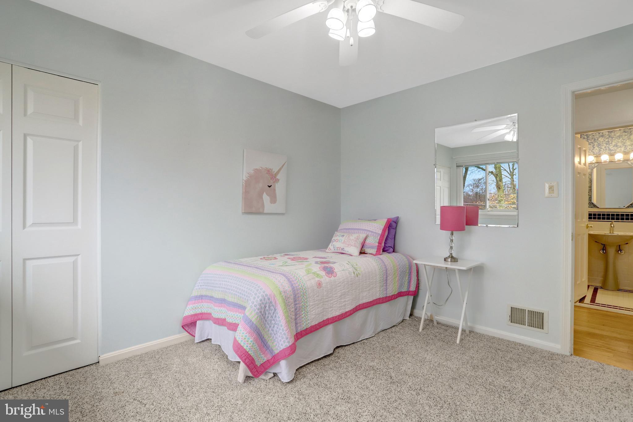 8816 Victoria Road Springfield, VA 22151 - Photo 45 of 76 a bedroom with a bed and a chandelier