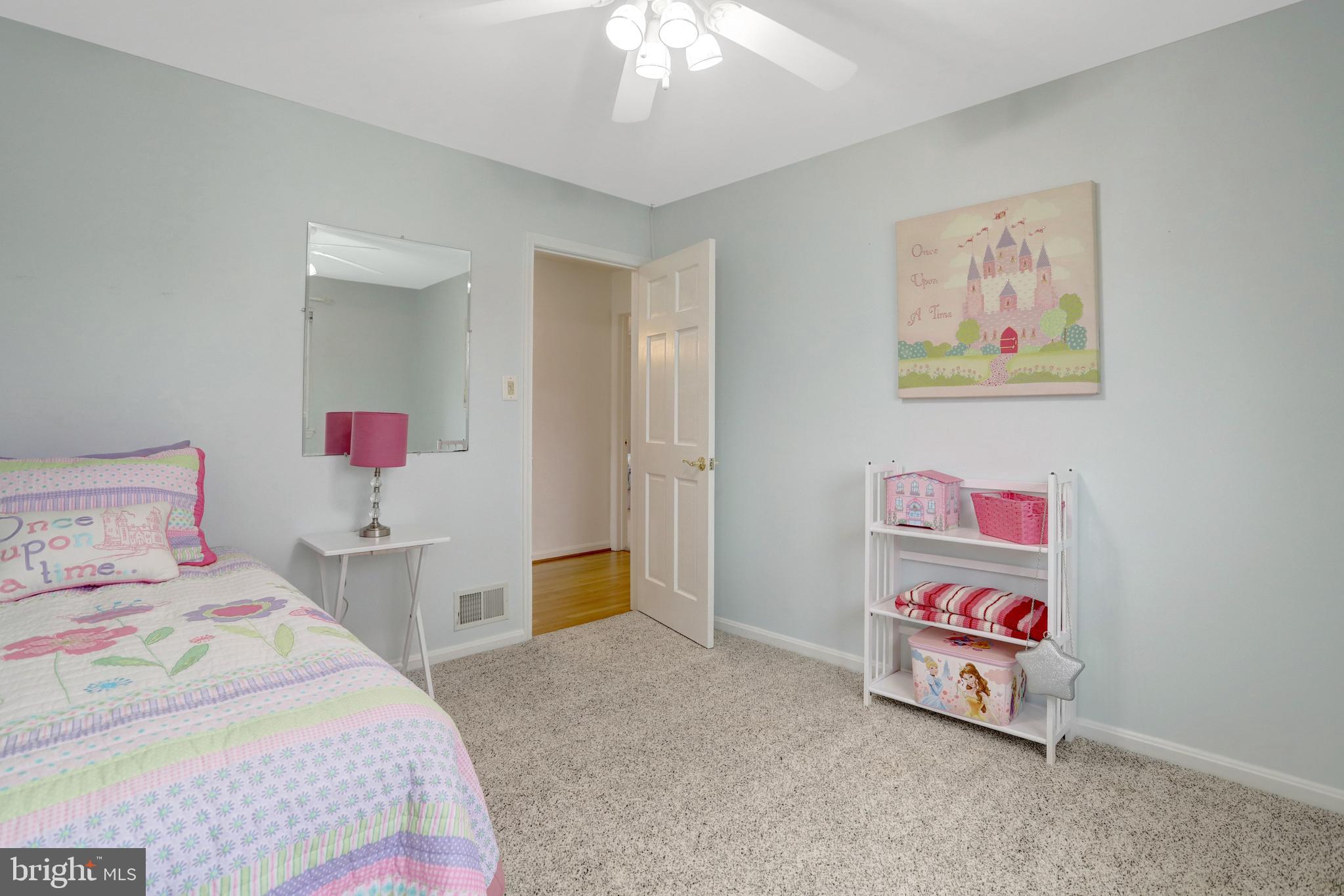 8816 Victoria Road Springfield, VA 22151 - Photo 46 of 76 a bedroom with a bed and painting on the wall