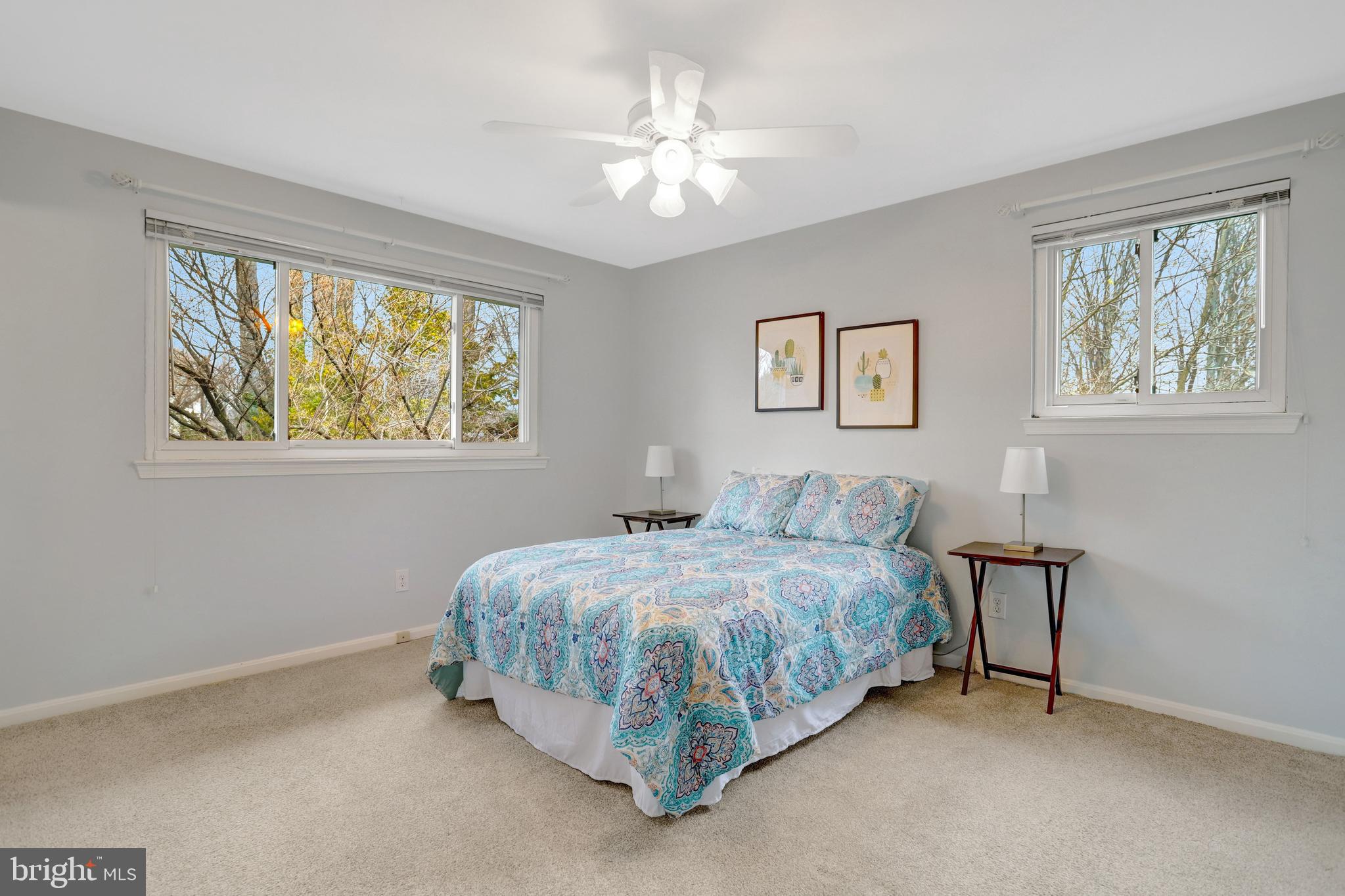 8816 Victoria Road Springfield, VA 22151 - Photo 48 of 76 a spacious bedroom with a bed and a painting on the wall