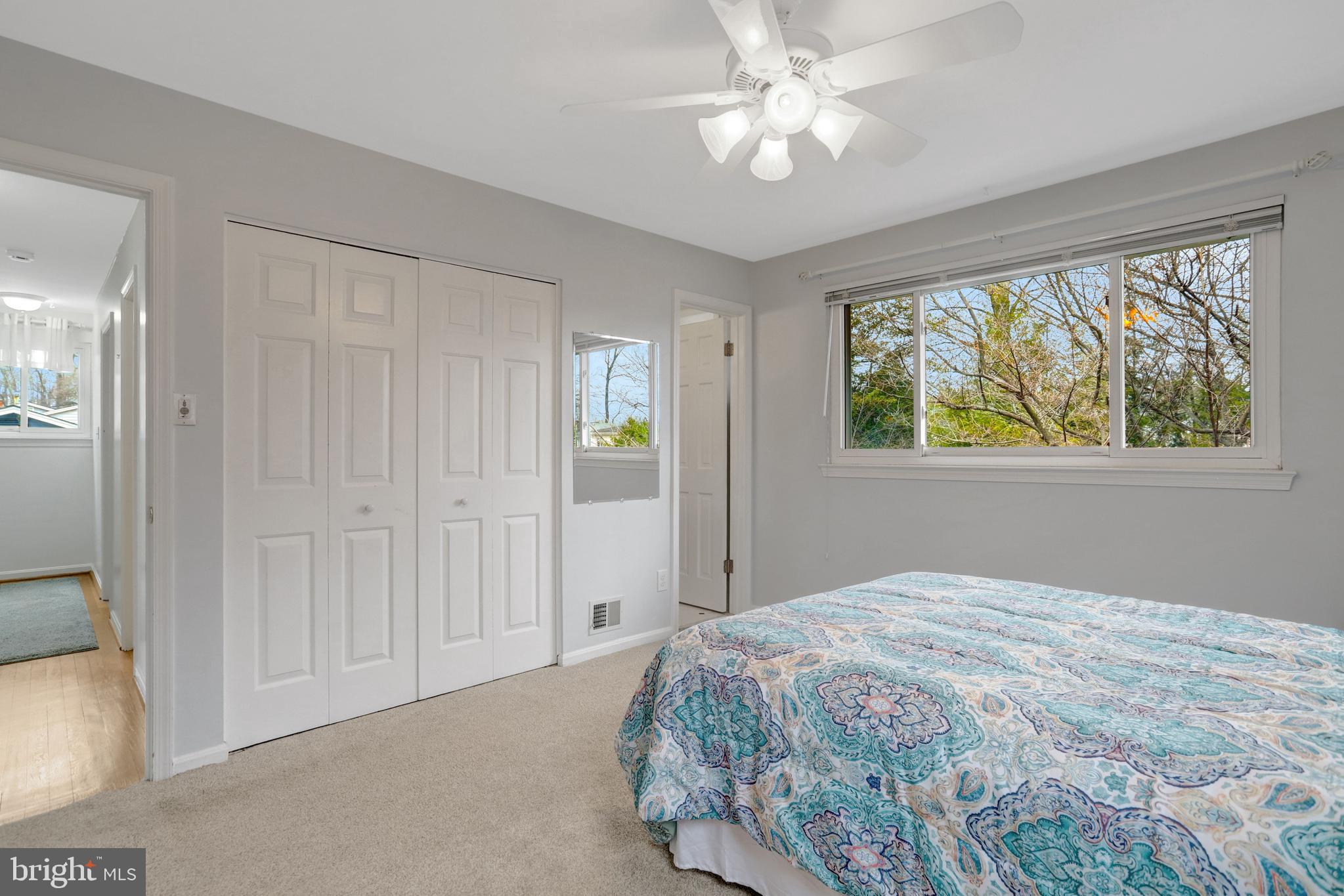 8816 Victoria Road Springfield, VA 22151 - Photo 49 of 76 a bedroom with a large bed and a chandelier