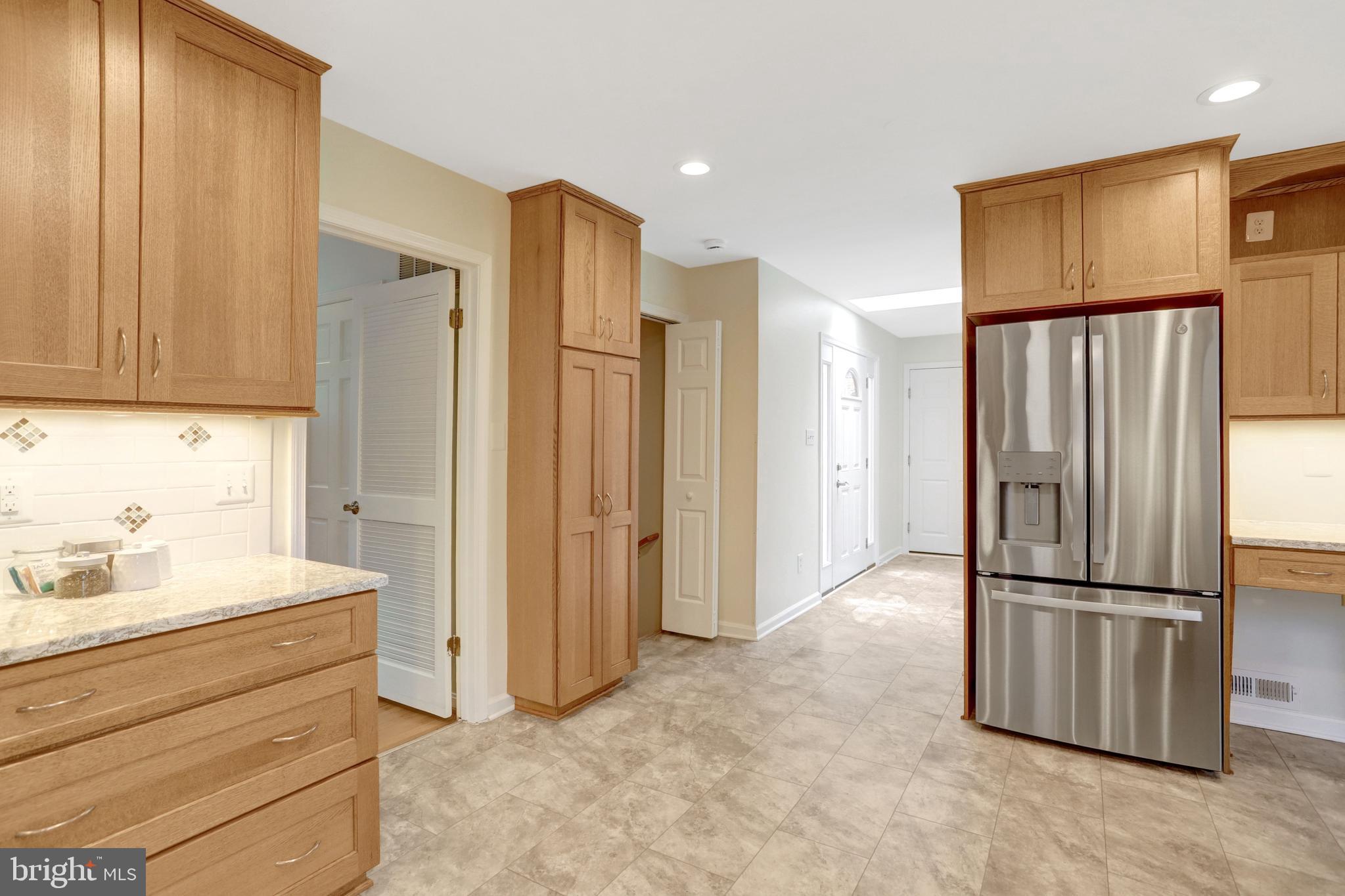 8816 Victoria Road Springfield, VA 22151 - Photo 10 of 76 a kitchen with stainless steel appliances granite countertop a refrigerator and a sink