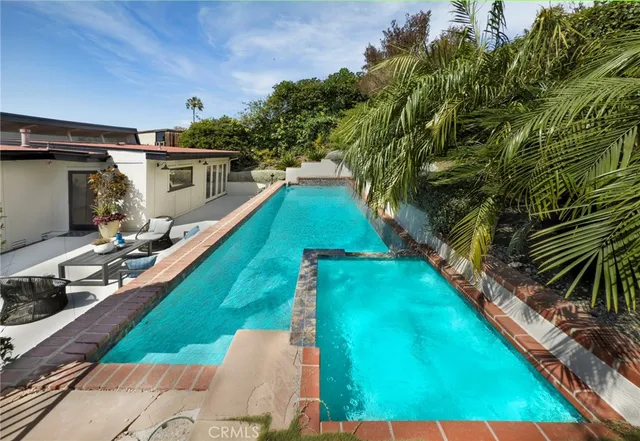 a view of a backyard with plants and a patio