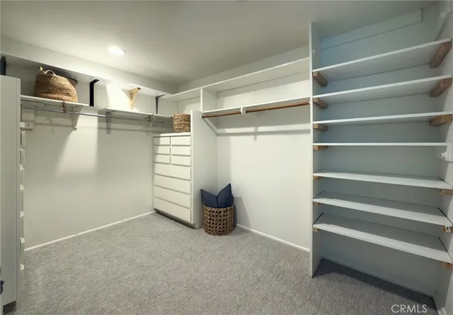 a view of walk in closet with empty racks