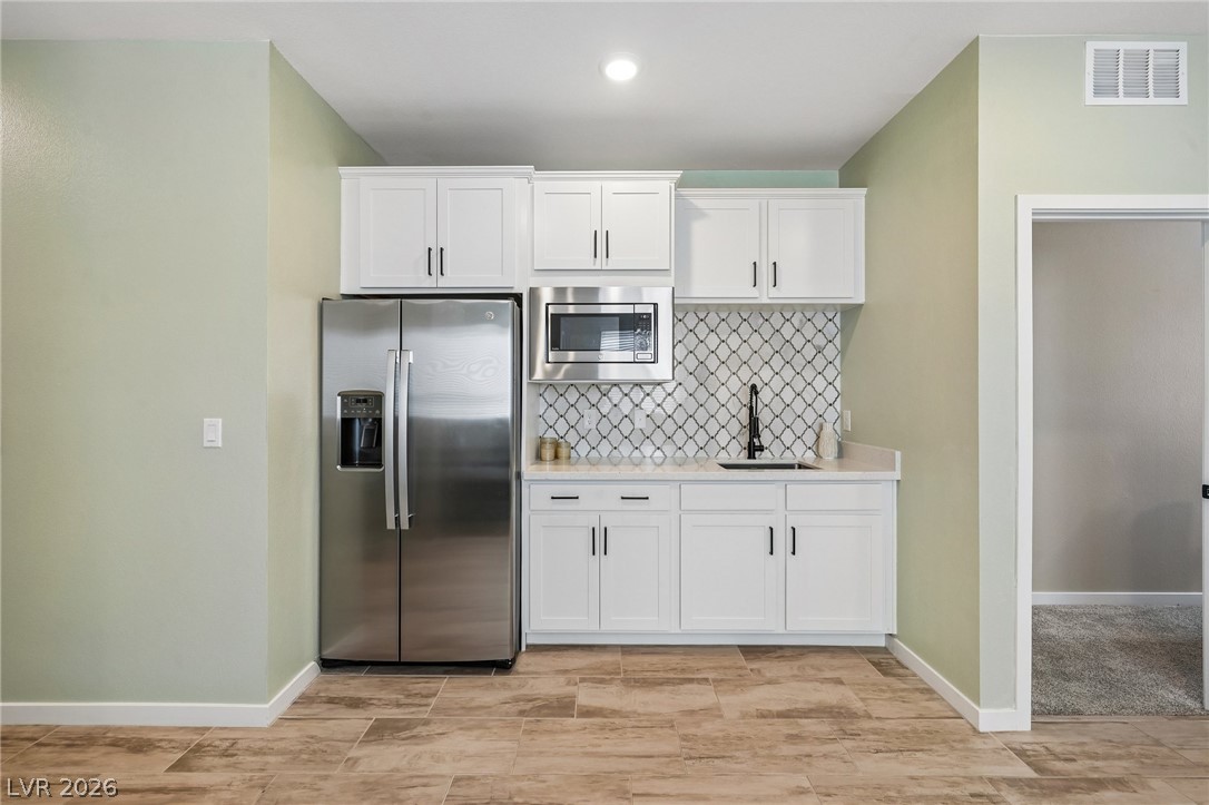 194 Viento Ridge Street Henderson, NV 89012 - Photo 20 of 72 Crisp cabinetry and modern finishes create a functional and stylish wet bar area.