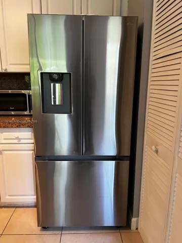 a city street lined with parked cars and buildings
