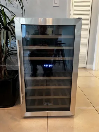 a living room with stainless steel appliances kitchen island granite countertop furniture and a large window