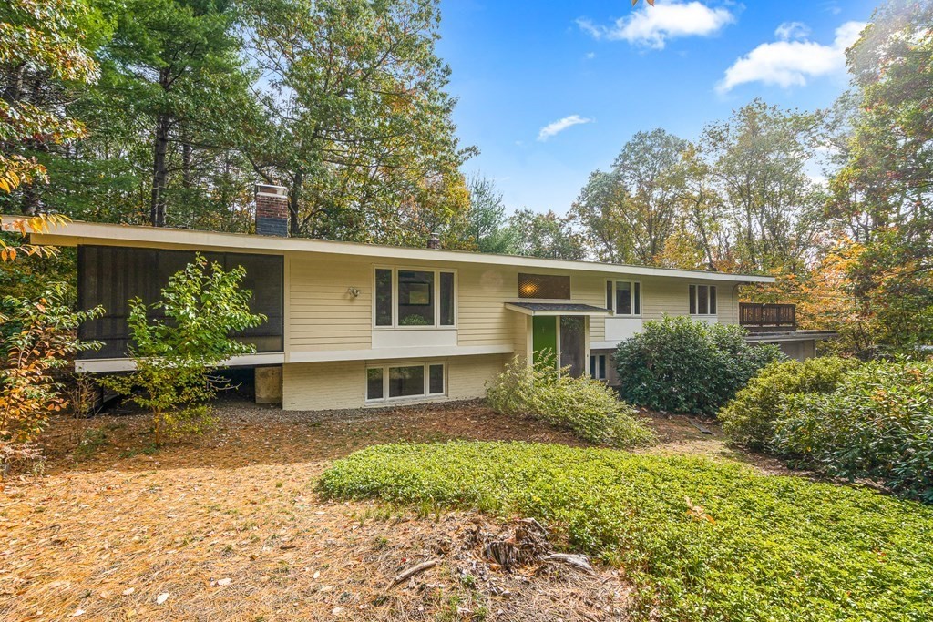 a front view of house with yard and green space
