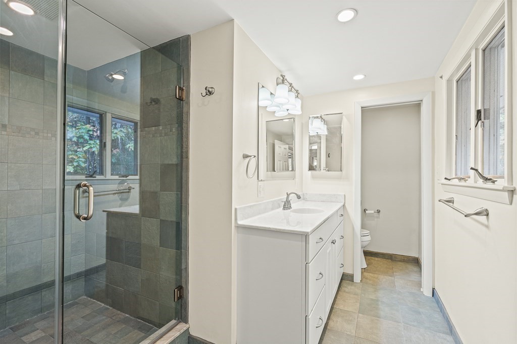 15 Partridge Road Lexington, MA 02420 - Photo 12 of 22 a spacious bathroom with a shower sink and mirror