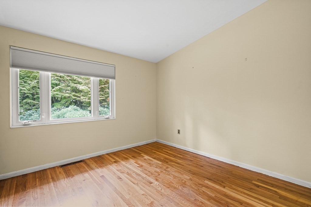 15 Partridge Road Lexington, MA 02420 - Photo 14 of 22 an empty room with wooden floor and windows