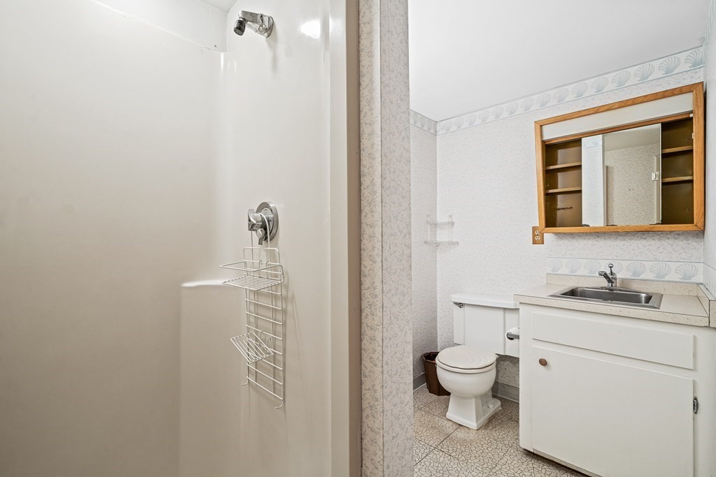 15 Partridge Road Lexington, MA 02420 - Photo 17 of 22 a bathroom with a toilet sink and mirror