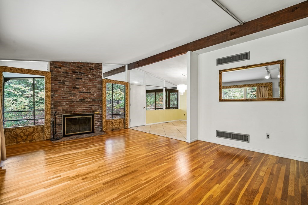 15 Partridge Road Lexington, MA 02420 - Photo 7 of 22 a view of a livingroom with wooden floor and a fireplace