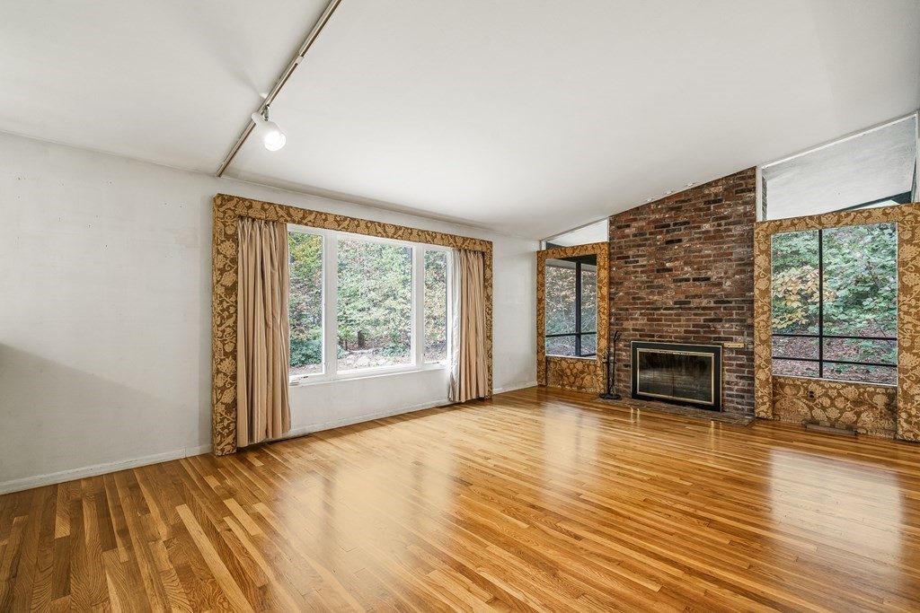 15 Partridge Road Lexington, MA 02420 - Photo 8 of 22 a view of empty room with wooden floor and fireplace