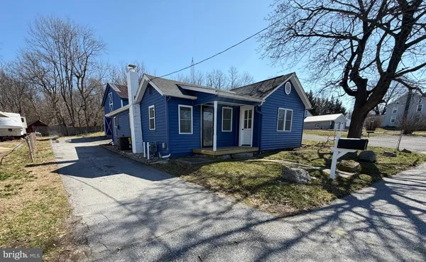 a view of a house with a yard covered in snow