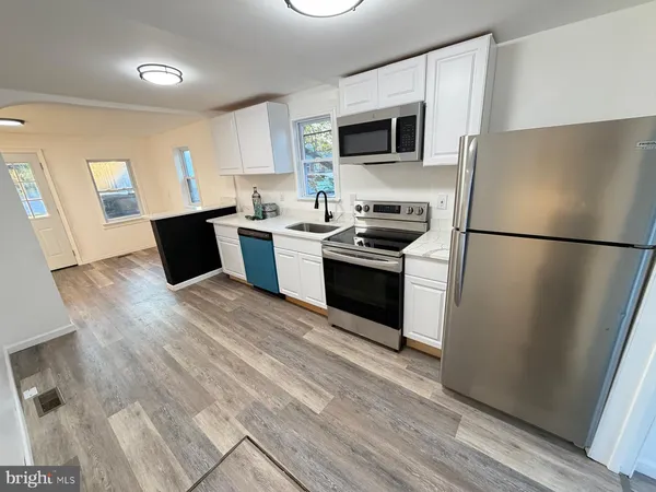 a kitchen with a refrigerator stove and microwave