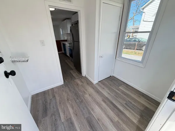 a view of hallway with wooden floor