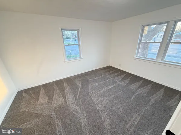 a view of an empty room with windows