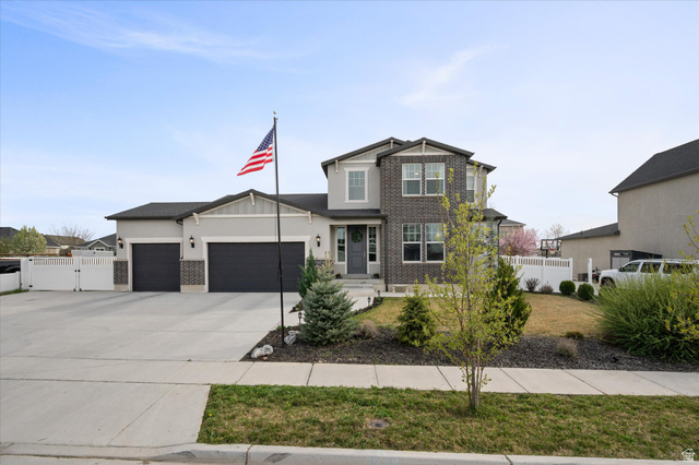 3359 Eurasian Crane Road Clinton, UT 84015 - Photo 2 of 71 Craftsman house with a garage, brick siding, a gate, concrete driveway, and stucco siding