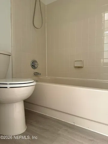 a bathroom with a bathtub and a toilet
